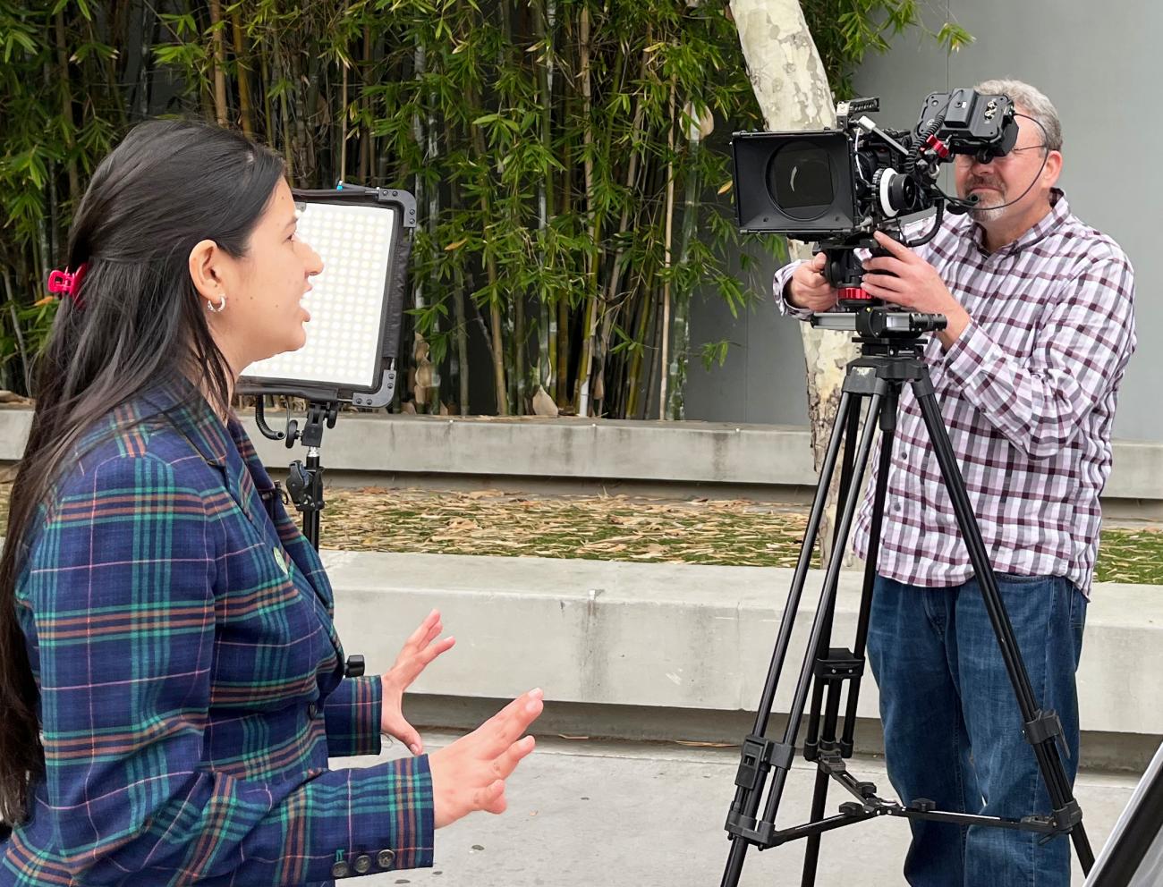 Young research fellow being interviewed by TV news station